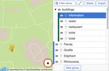 A screenshot of a custom MapHub zoo map showing the new directions button, an arrow icon for route planning, displayed in the bottom-right corner. access to route planning from their location to a selected point.